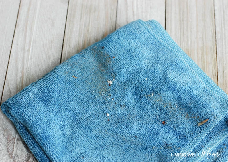 A blue microfiber cloth with dust and dirt on it