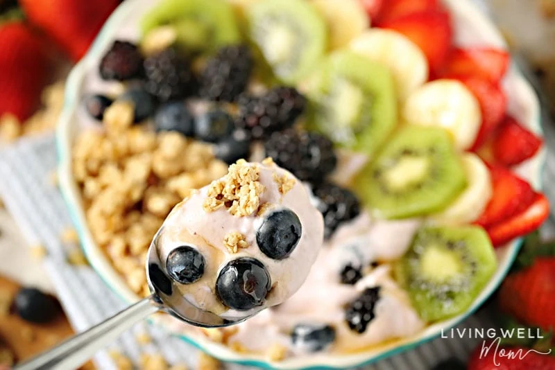 spoonful of delicious fruit granola yogurt bowl
