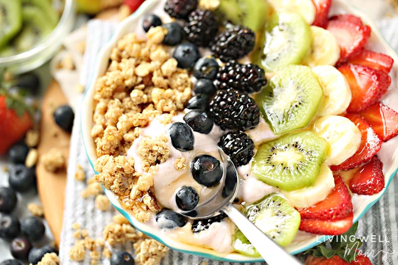 fruit granola and yogurt bowl with spoon