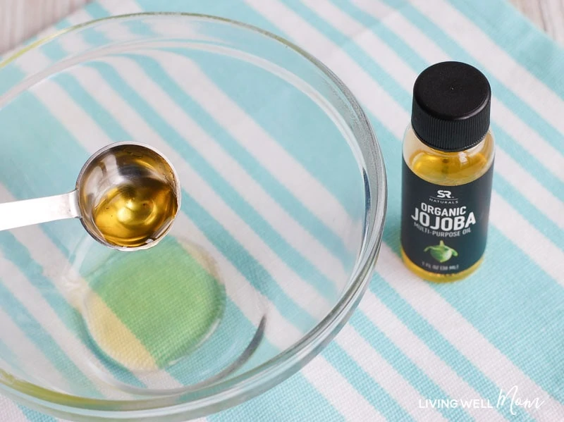 essential oil being poured into a bowl 