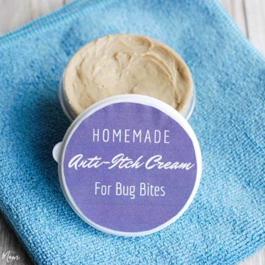 homemade anti-itch cream for bug bites with purple label container on blue towel