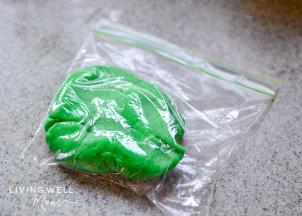Green playdough stored in a small ziplock bag.