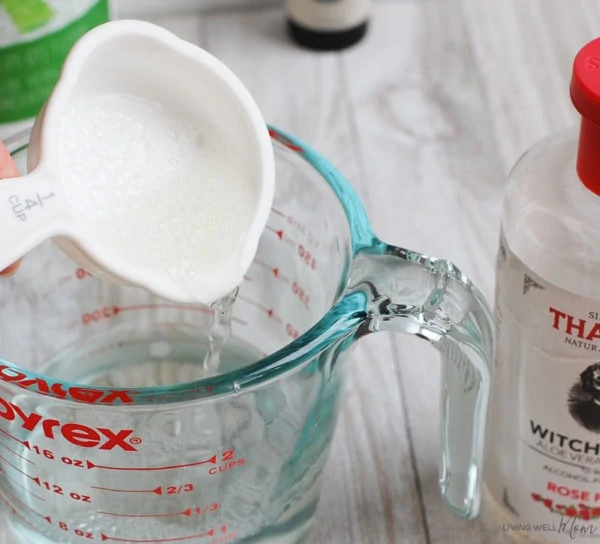 mixing witch hazel in glass cup for homemade face toner