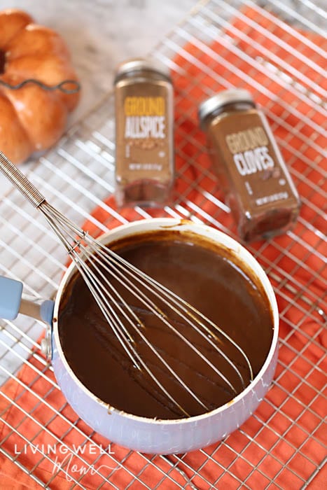 whisking pumpkin spice sauce in a sauce pan