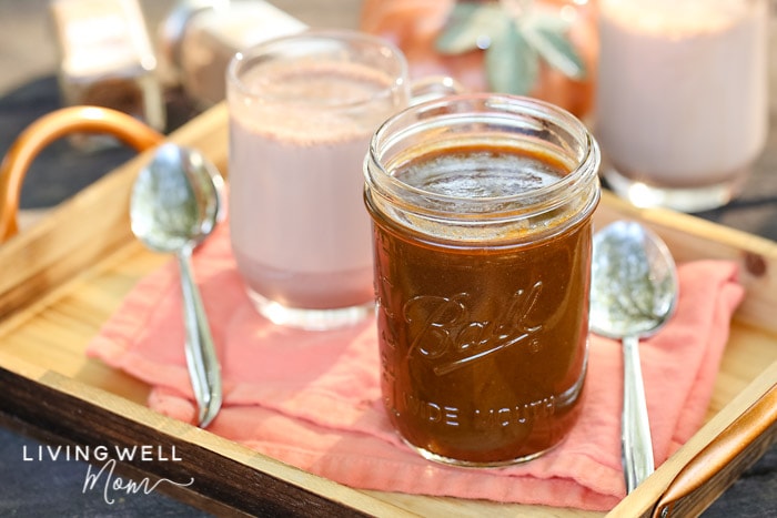 homemade pumpkin sauce next to a cup of hot cocoa