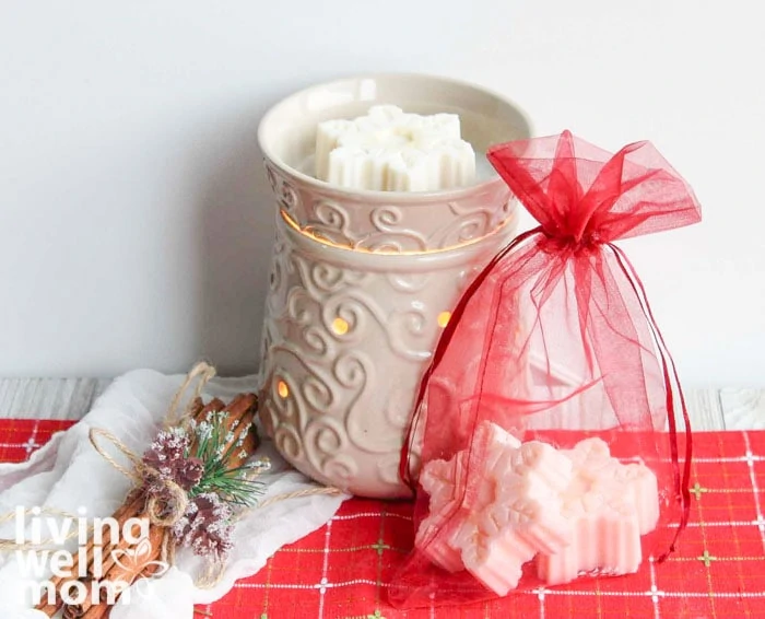 homemade scented wax melts for Christmas in a warmer with red gift bag