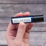 essential oil roll on bottle labeled with skin soother