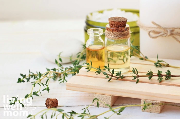 thyme leaves with essential oil bottles