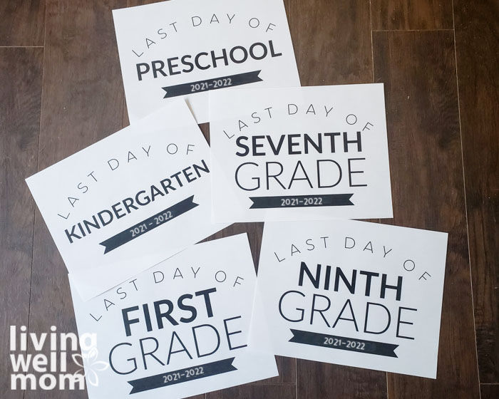 sample layout of last day of school signs 2022 on dark wood background