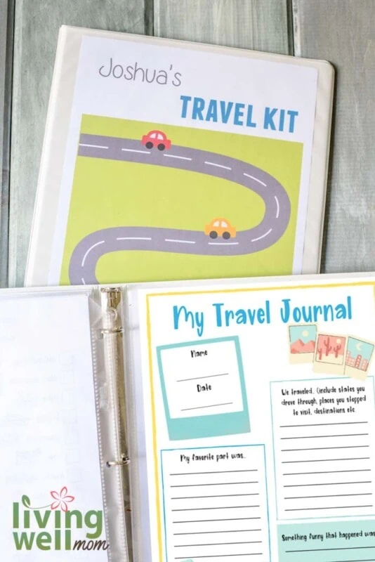 my travel journal printed page in white binder with travel kit binder on blue wood background