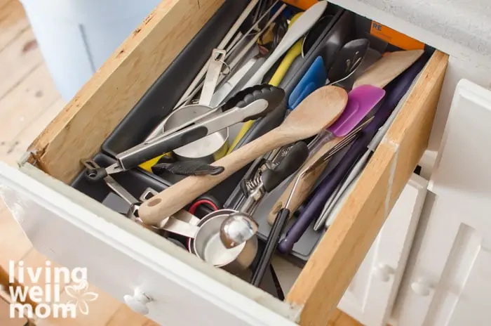 a messy utensil drawer in a kitchen