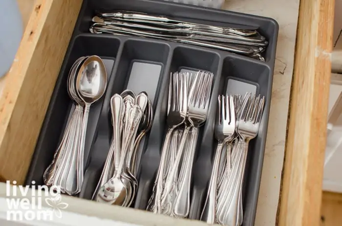 a utensil tray in a drawer, with forks spoons and knives inside