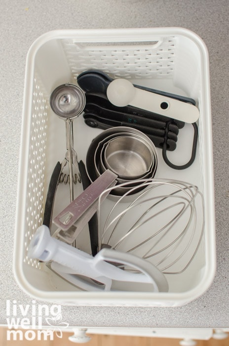 a white basket filled with baking tools