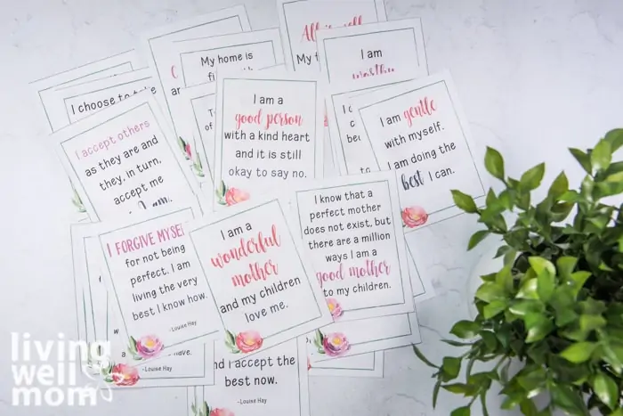 daily affirmation prompts for moms piled on a countertop