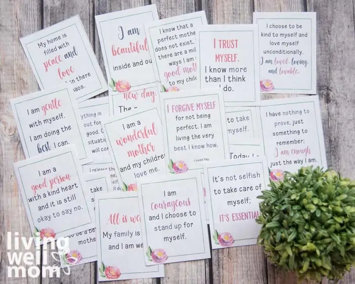 affirmation cards laid on a wooden surface, with positive statements typed on each one