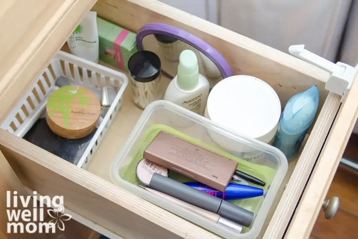 makeup stored in plastic bins in a bathroom drawer