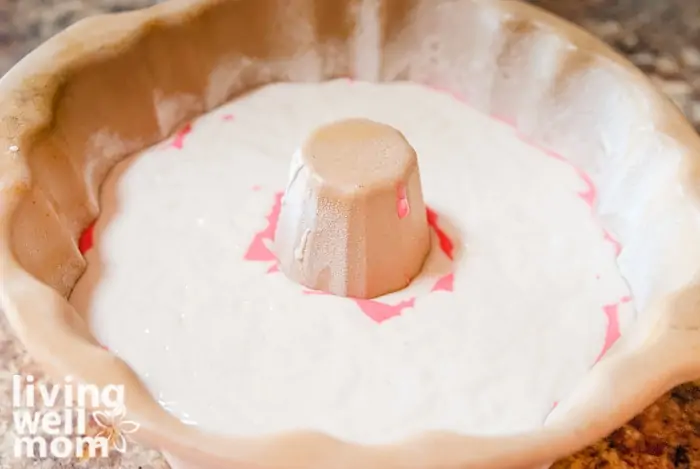 White and pink layered peppermint cake in a bundt pan