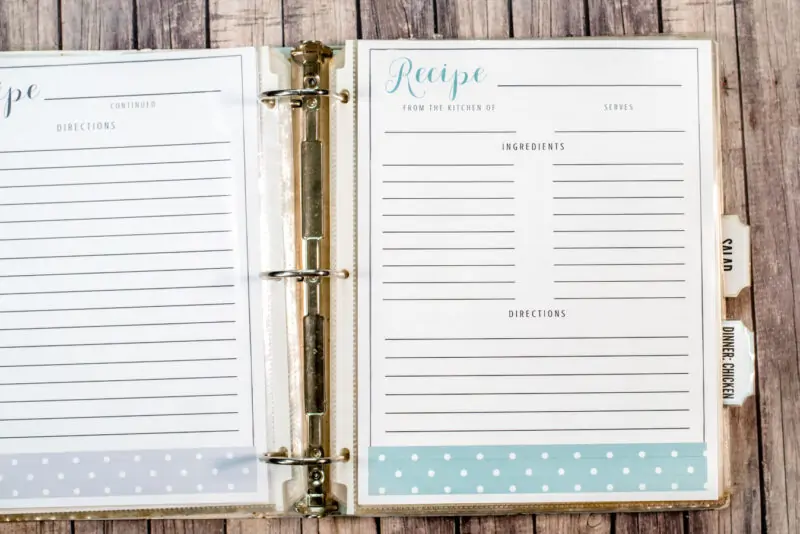 binder opened to blank recipe page with blue design on wood background