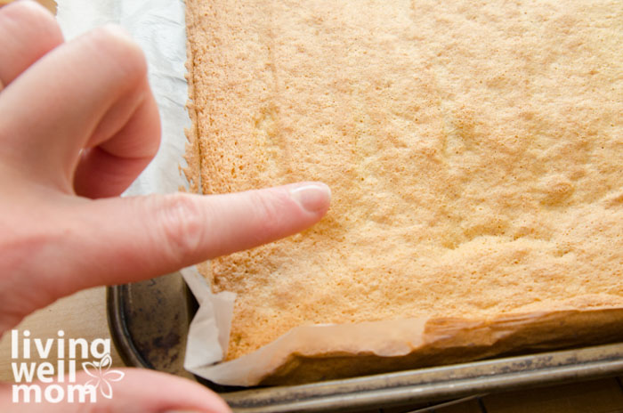 checking the bounce back of baked pumpkin sponge cake