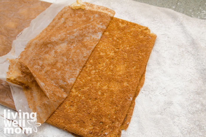 peeling parchment paper off of pumpkin spice roll