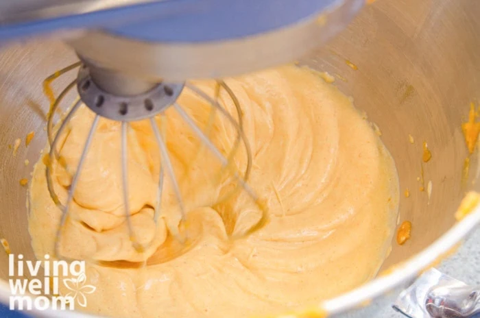 adding pumpkin puree to ingredients