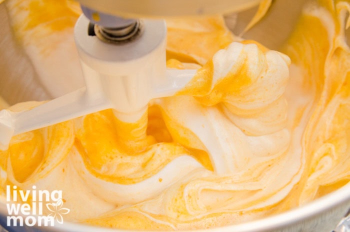 combing egg whites and sugar mixture with egg yolks and pumpkin mixture 