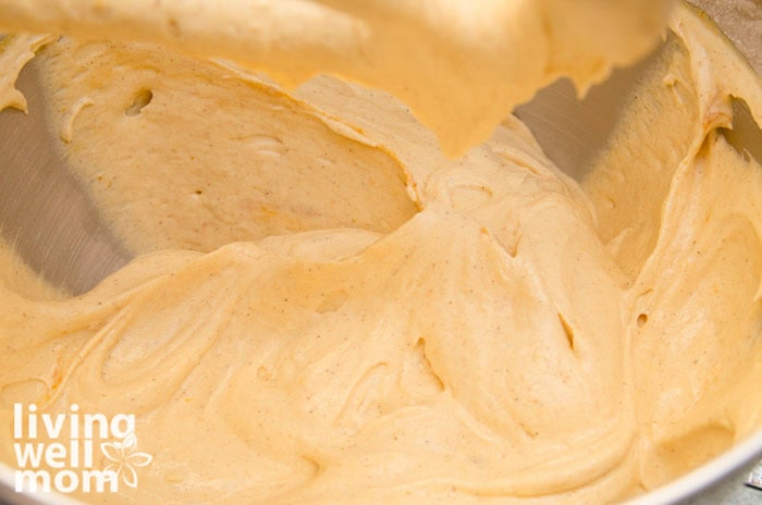 adding dry ingredients into pumpkin roll mixture