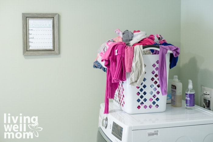 a hamper on top of a clothes dryer