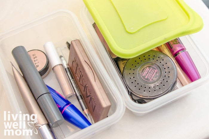 two plastic containers with lids holding makeup
