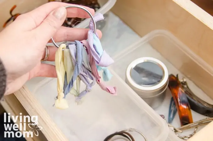 ponytail holders on a shower curtain hook