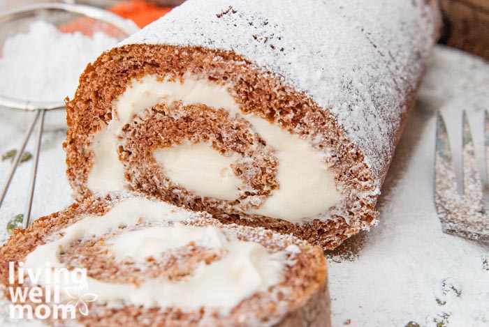 close up of a spiced pumpkin roll being cut into slices
