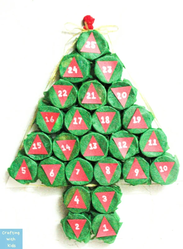 a DIY advent countdown made out of tissue paper and toilet paper rolls