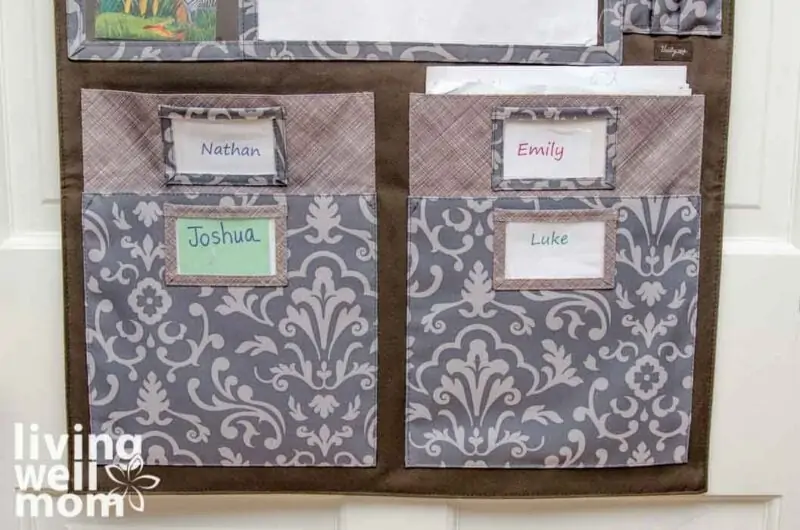 four fabric file holders with kids names labeled on each