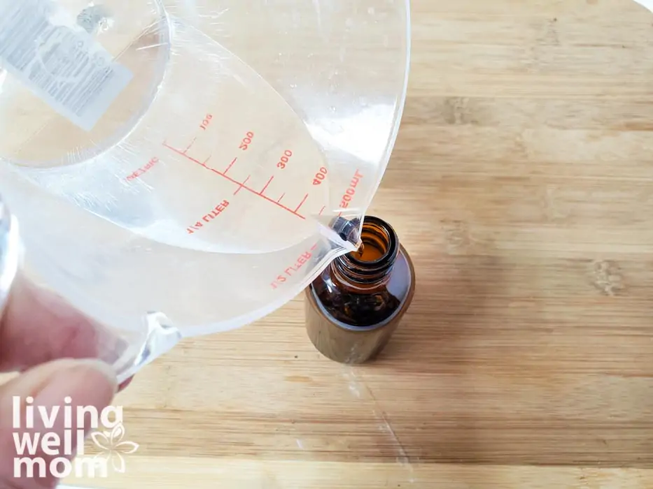 liquid being poured into a small glass container