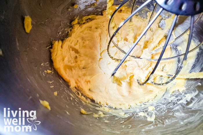 Shea butter and coconut oil being whisked in a mixing bowl. 