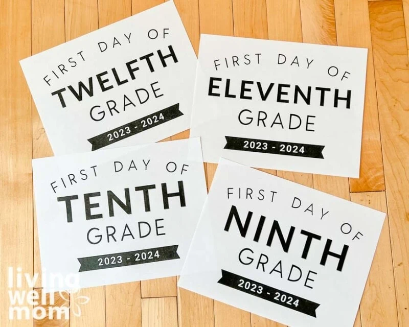 printable first day of school signs on a wood floor
