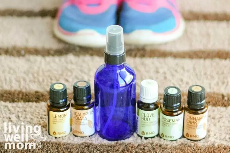glass bottle and essential oils all in a row with sneakers in the background
