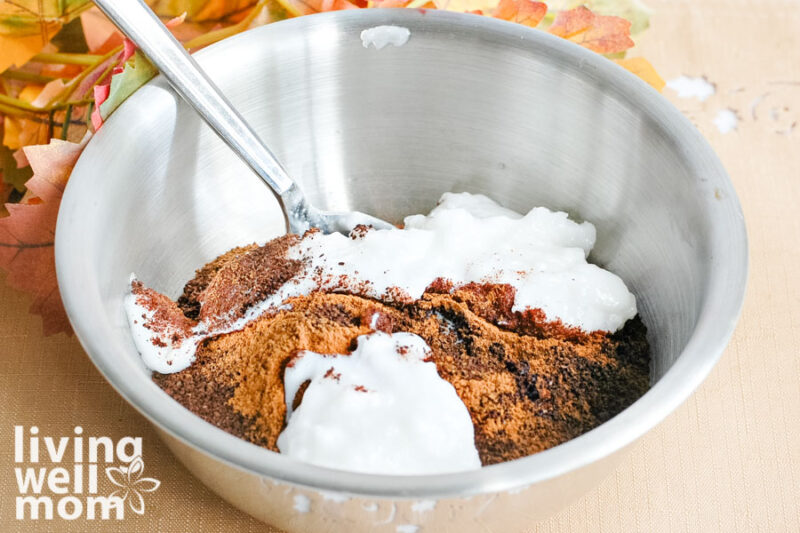 unrefined coconut oil being mixed into dry ingredients for DIY coffee face scrub