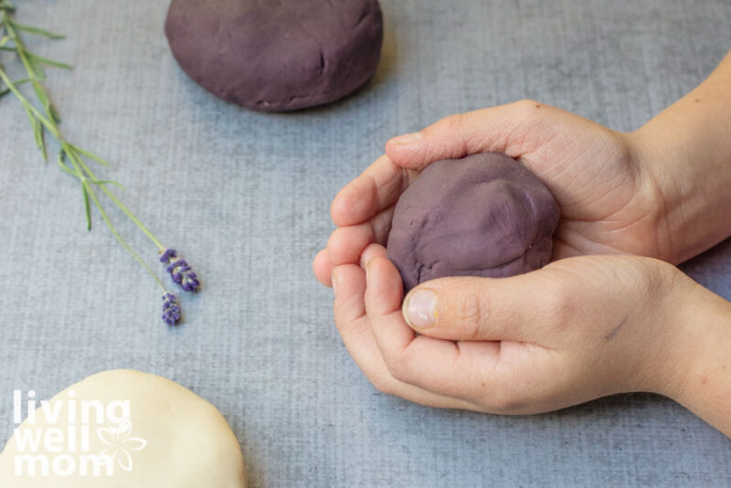 calming homemade modeling dough balled up in a child's hands