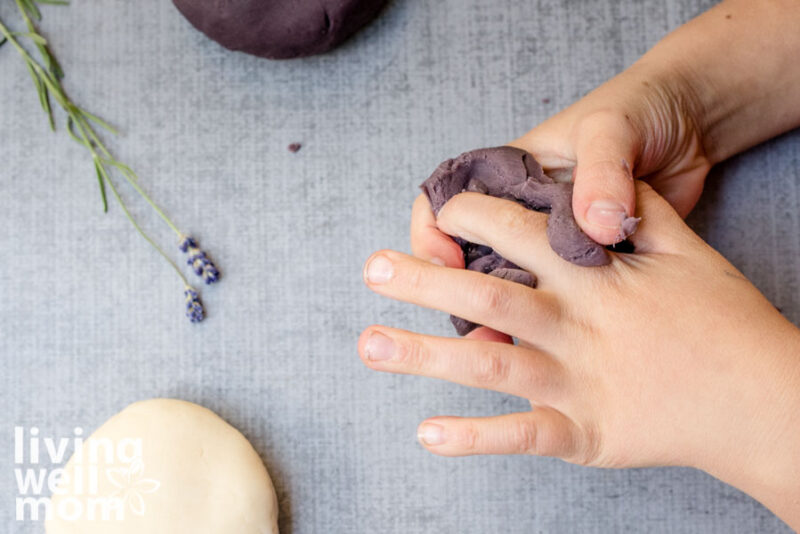child playing with DIY playdoh with lavender essential oils mixed in