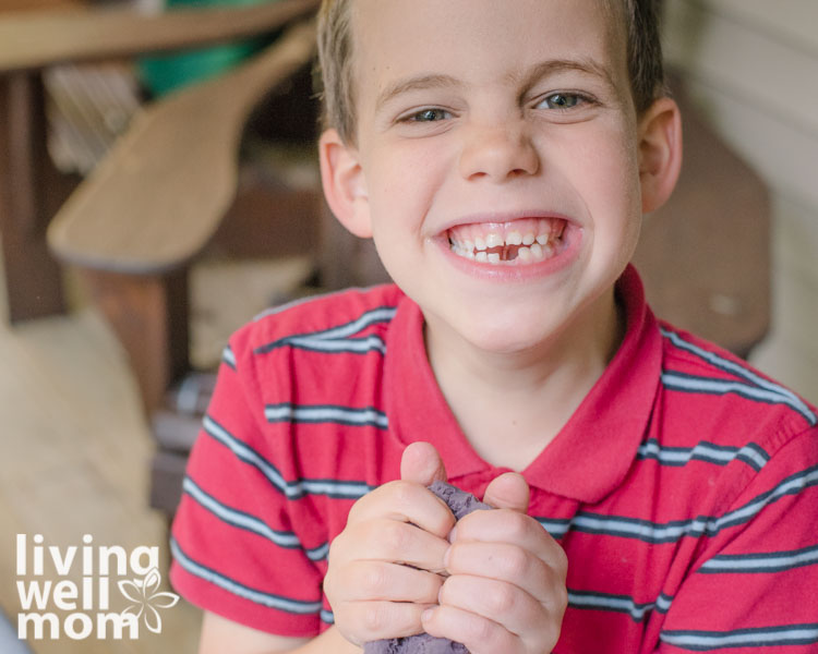 boy squishing calming playdough made with lavender oil