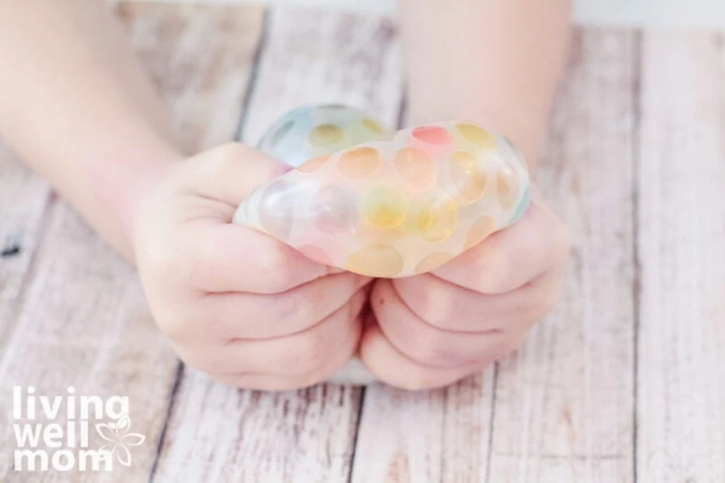 kids squeezing orbeez filled stressball