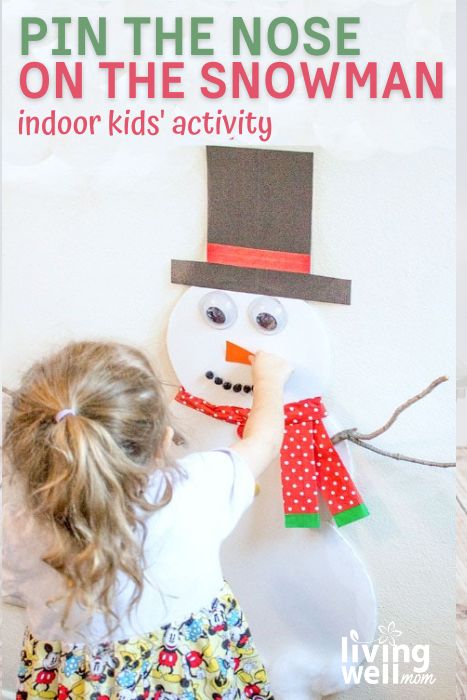 girl playing pin the nose on the snowman