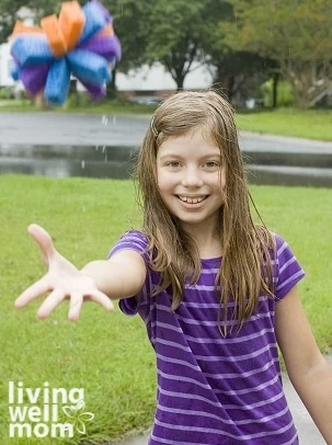 girl tossing a DIY water ball