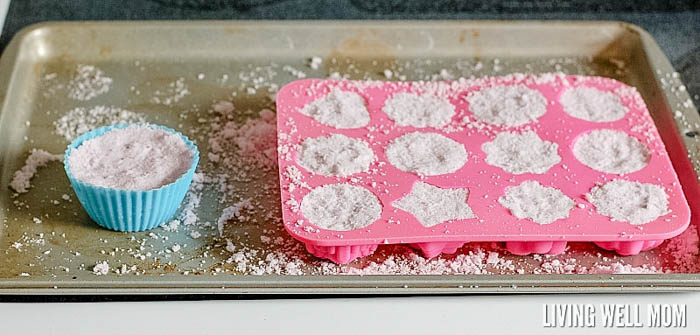 putting DIY bath bombs mixture into molds