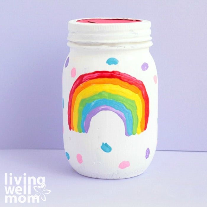 rainbow piggy bank in front of purple background
