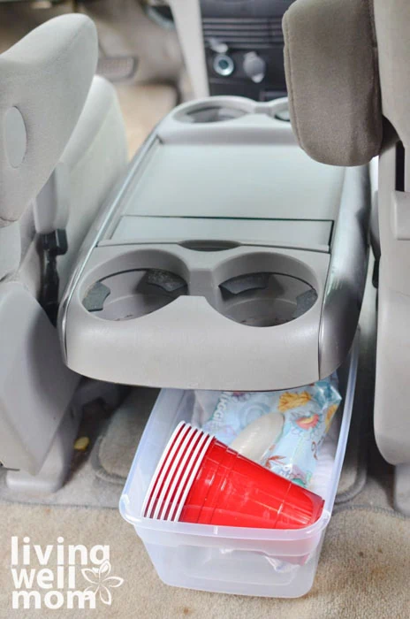 wipes and cups in a plastic bin under center console