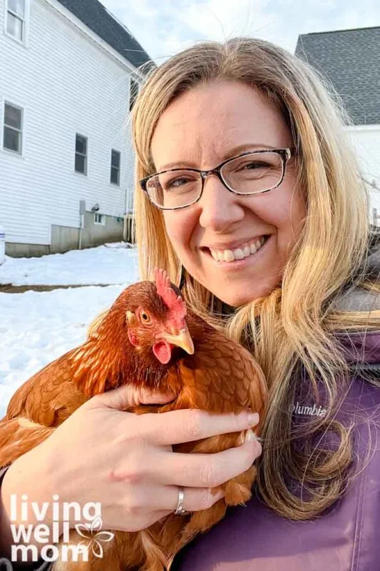 blonde woman with glasses holding a red orange chicken