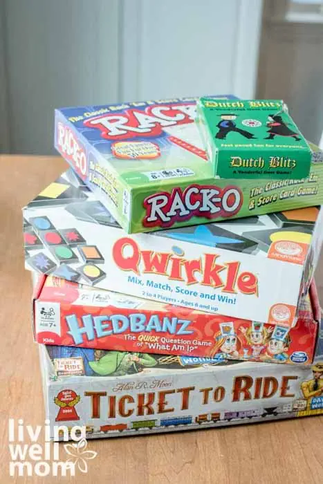 Dutch Blitz, Rack-O, Qwirkle, Hedbanz & Ticket to Ride on a table for family game night
