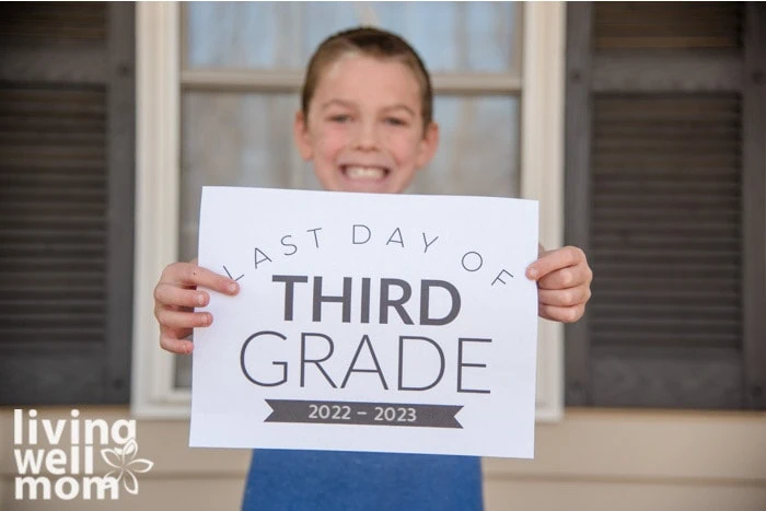 boy holding last day of third grade printable sign